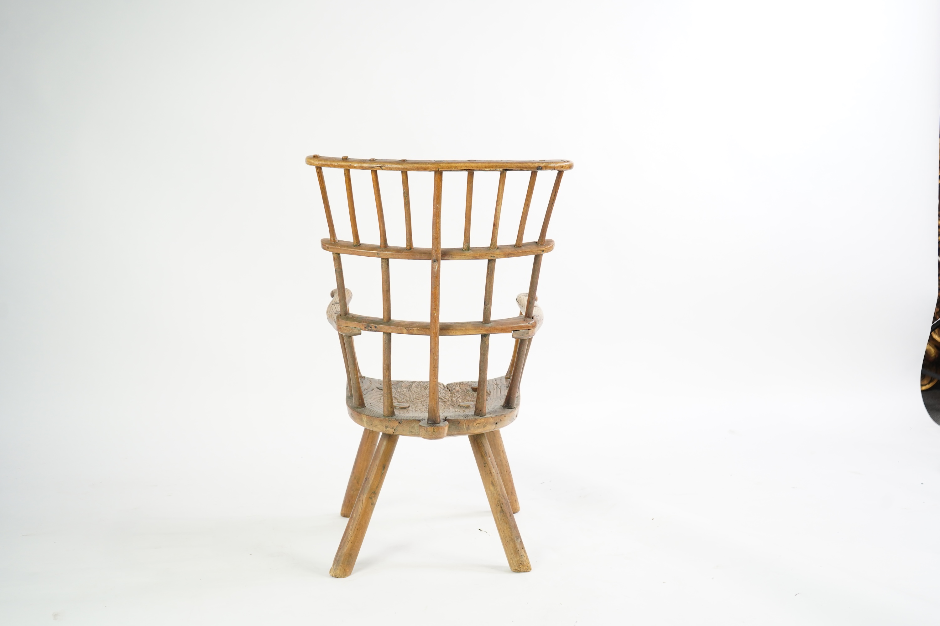 An 18th or 19th century primitive ash and elm Windsor armchair